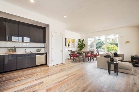 A modern kitchen with dark brown cabinets and a white countertop.