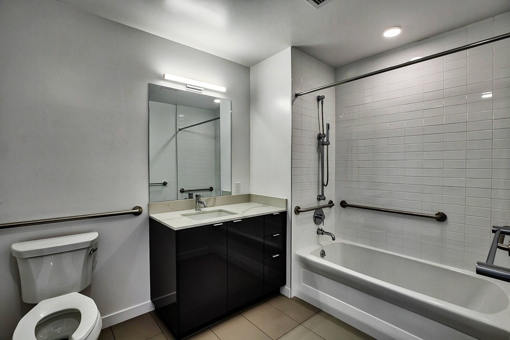 A bathroom with a toilet, sink, and bathtub.at 5263 W Adams, Los Angeles, CA 90016