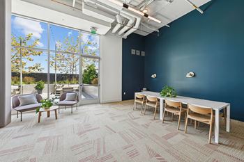 A room with a long table and chairs with a view of the outside.at 2221 S Western, Los Angeles, CA