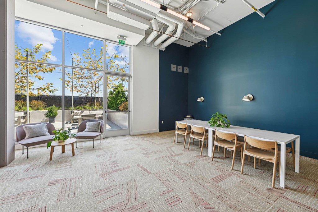 A room with a long table and chairs with a view of the outside.at 2221 S Western, Los Angeles, CA 90018