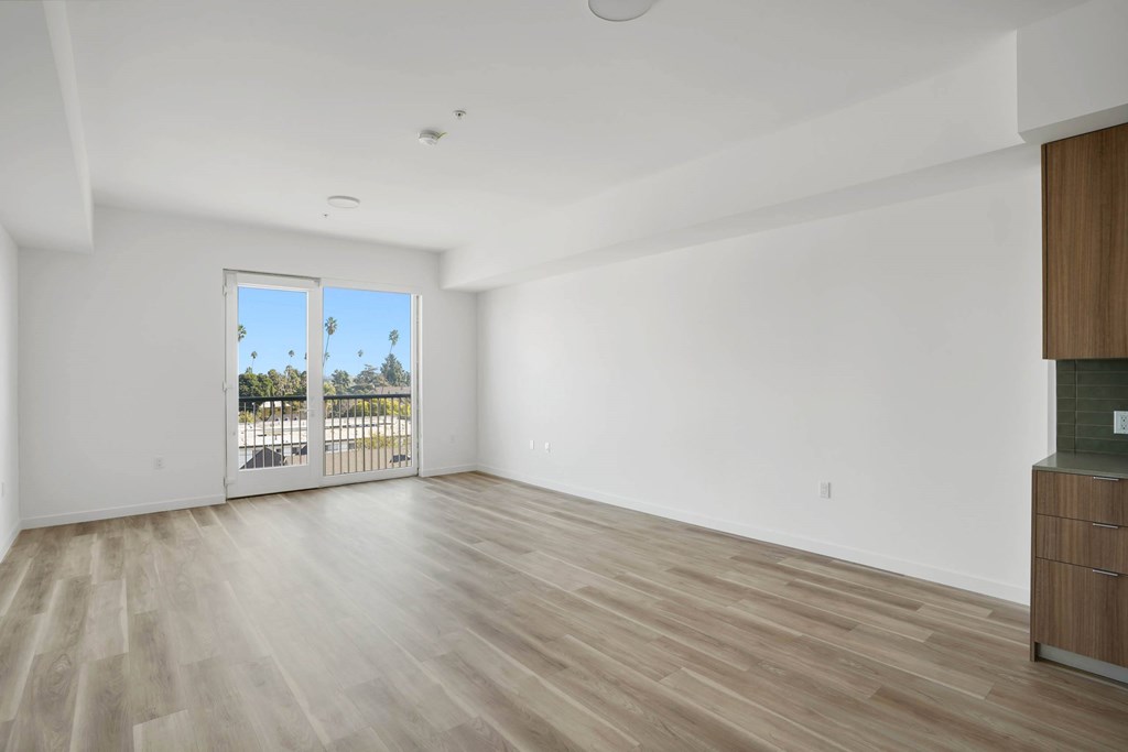 A room with a sliding glass door leading to a balcony.at 2221 S Western, California