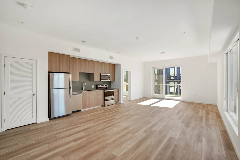 A kitchen with wooden floors and stainless steel appliances.at 2221 S Western, Los Angeles, CA 90018
