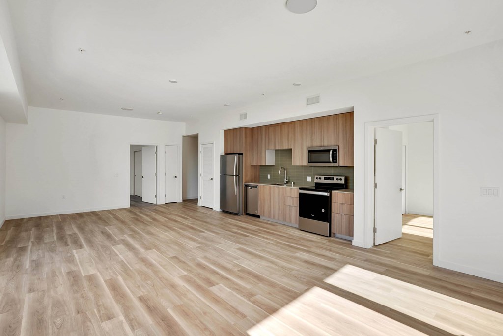 A spacious kitchen with wooden floors and modern appliances.at 2221 S Western, Los Angeles