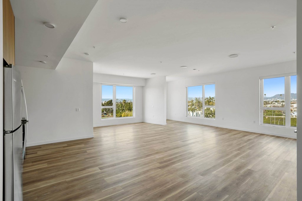 A spacious room with wooden floors and white walls.at 2221 S Western, Los Angeles, CA 90018