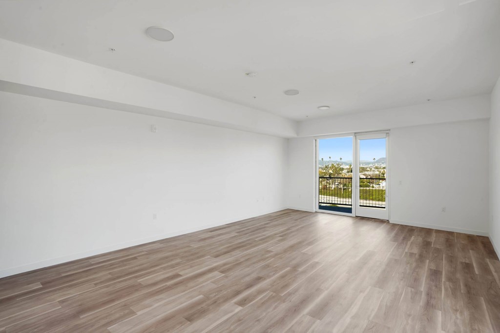 A room with wooden flooring and a window overlooking a balcony.at 2221 S Western, California, 90018