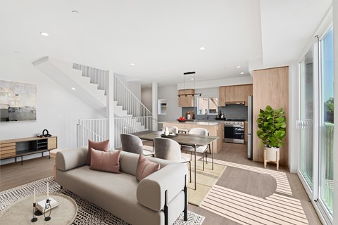 A modern living room with a staircase leading to the upper floor.
