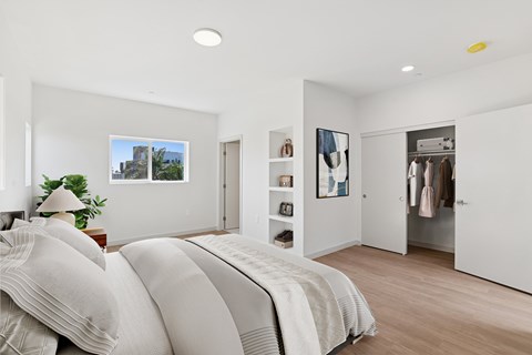A bedroom with a large bed and a wardrobe.