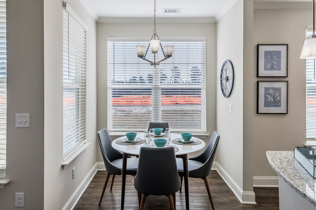 A dining room with a table set for four at Leland Station apartments, Leland 28451