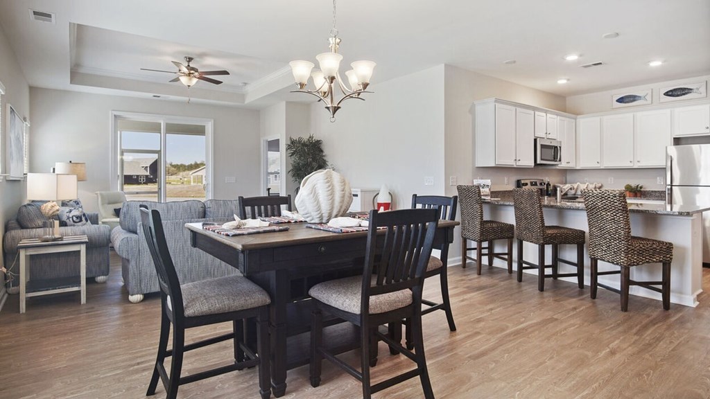 A dining room with a table set for six at Stepping Stone at Bridgewater Apartments, Little River, South Carolina