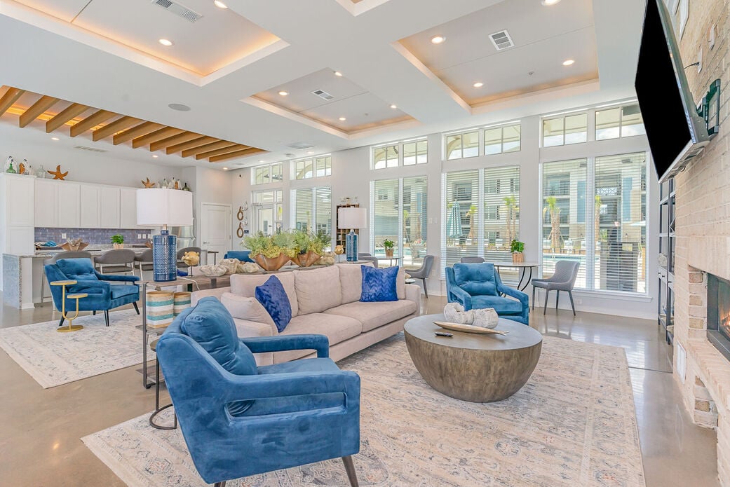 A living room with blue chairs and a white couch.