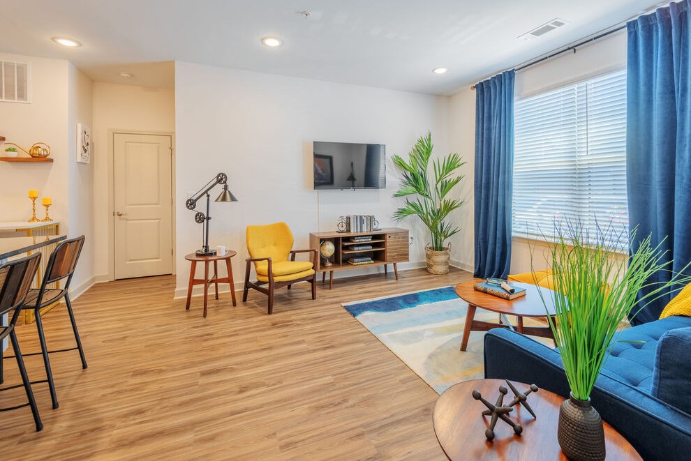 Living Room With TV at Riverside Flats at Aberfoyle Village, North Carolina, 28012