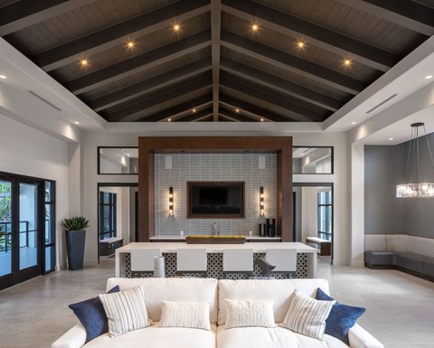 A modern living room with a white couch and a fireplace at Las Palmas Apartments, Florida 33913