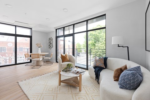 A living room with a white couch and a coffee table.