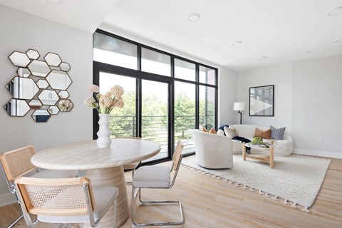 A modern dining room with a round table and chairs.