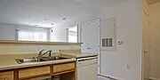 A kitchen with a sink and a window.