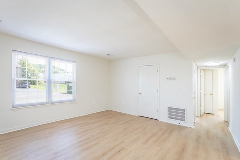 A room with wooden floors and white walls.