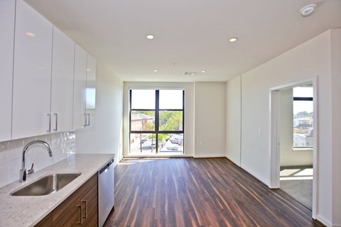 A kitchen with white cabinets and a sink.