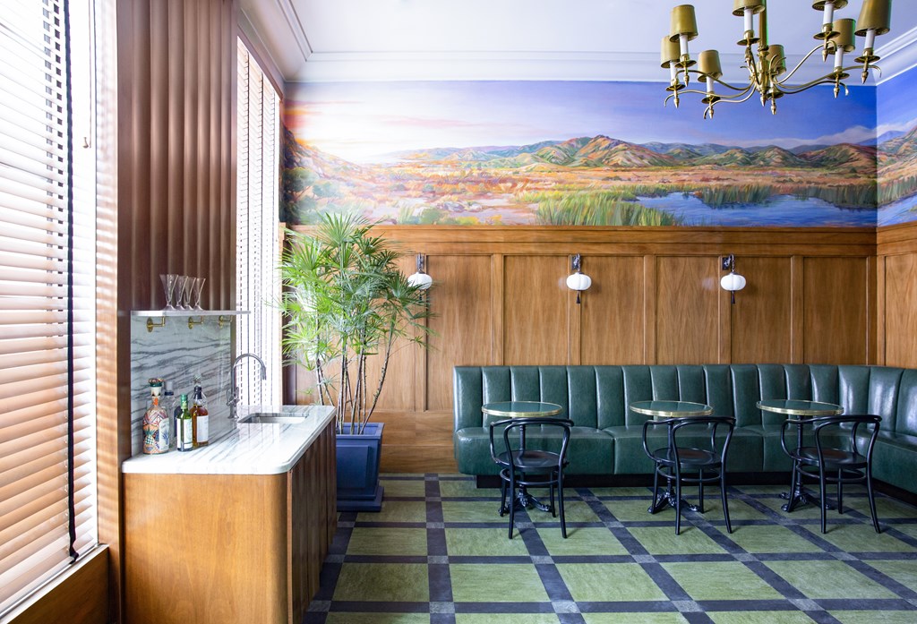 A bar with a large mural on the wall.