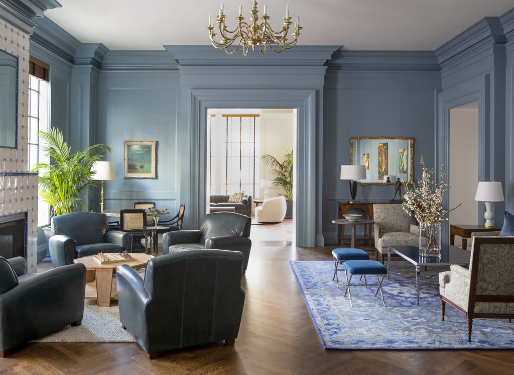 A large room with a chandelier and a fireplace.