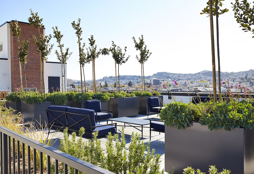 A rooftop patio with a table and chairs.
