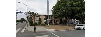 A person is crossing the street at a crosswalk.
