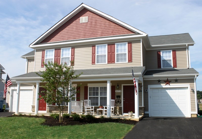 A house with a red door and a flag on the front.