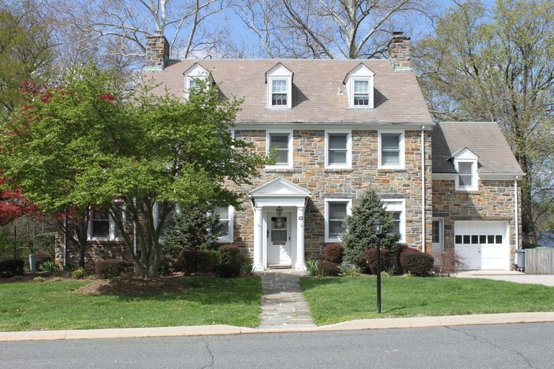 A house with a white door and a small porch.
