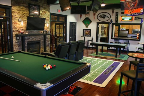 A pool table with a green cloth and a set of balls on it.