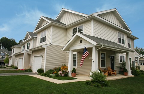 A house with a flag on the front porch.