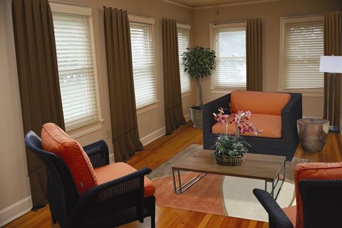 A living room with a sofa, chairs, and a coffee table.