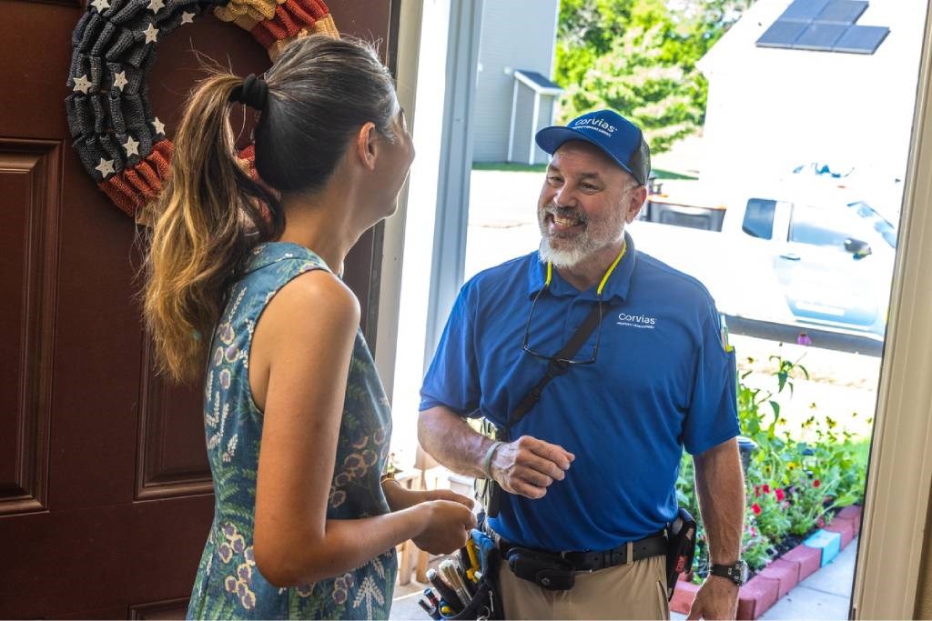 A man in a blue shirt is talking to a woman in a blue dress.