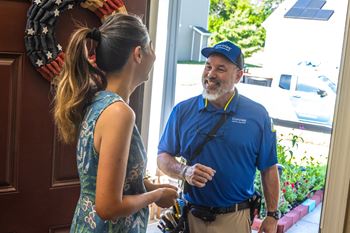 A man in a blue shirt is talking to a woman in a blue dress.