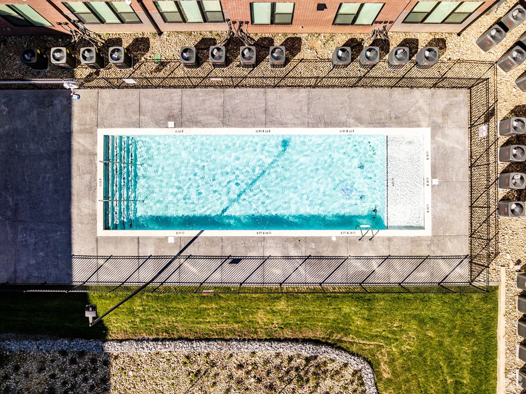 A rectangular pool with a diving board on the side.