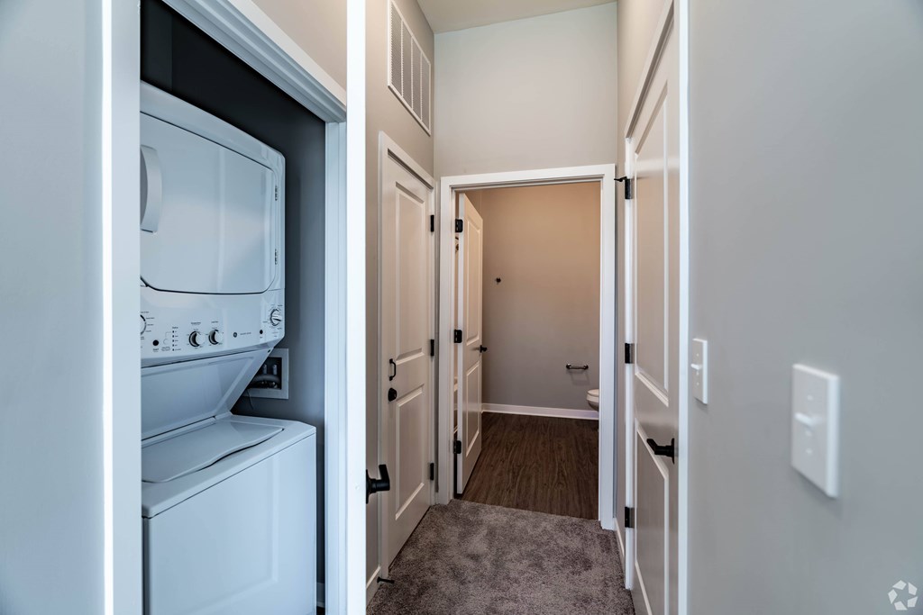 A white washer and dryer in a small laundry room.