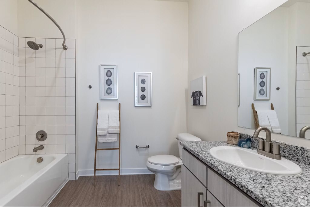 A bathroom with a white sink, toilet, and bathtub.