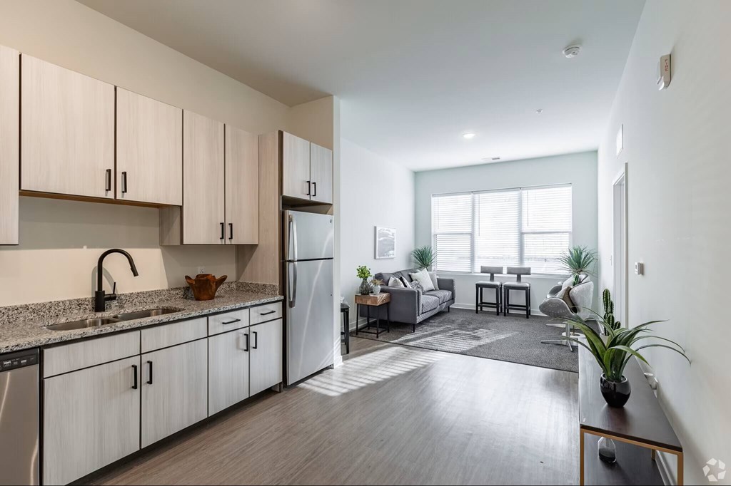 A kitchen with wooden cabinets and a refrigerator.