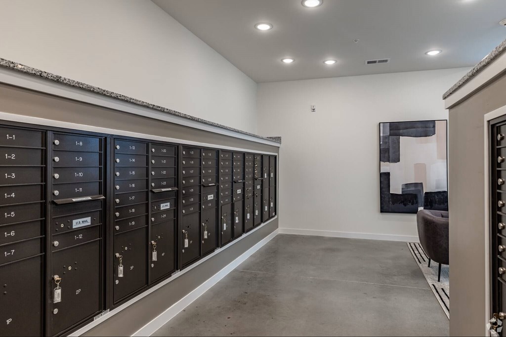 A row of mailboxes are lined up against a wall.
