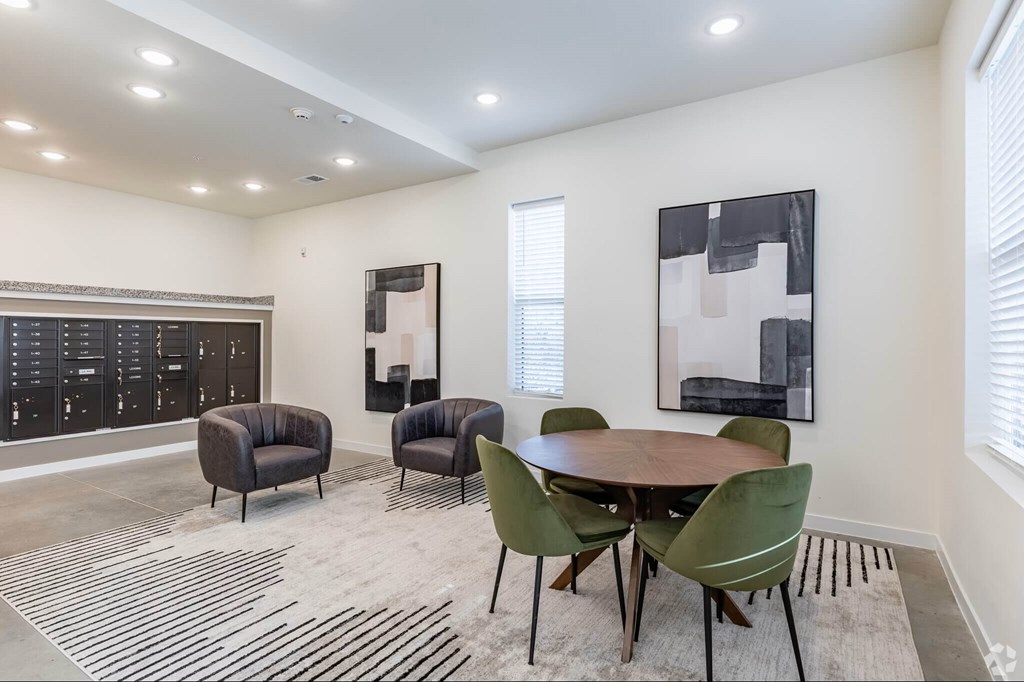 A modern dining room with a wooden table and green chairs.