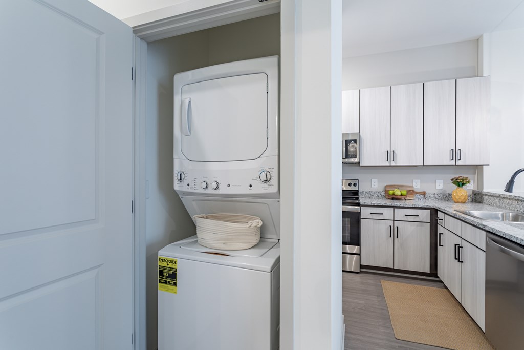 A white oven with a sticker on it is in a kitchen.