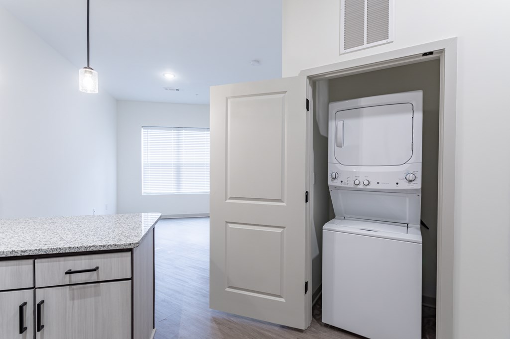 A white oven is built into a cabinet in a kitchen.