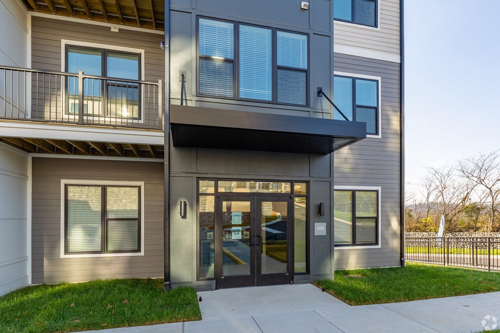 A modern two-story building with a balcony on the upper floor.