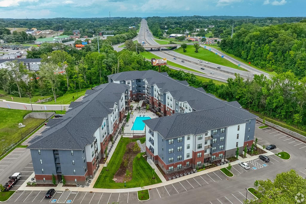 A large apartment complex with a swimming pool in the middle.
