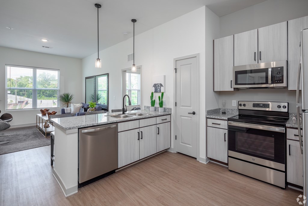 A modern kitchen with stainless steel appliances and white cabinets.