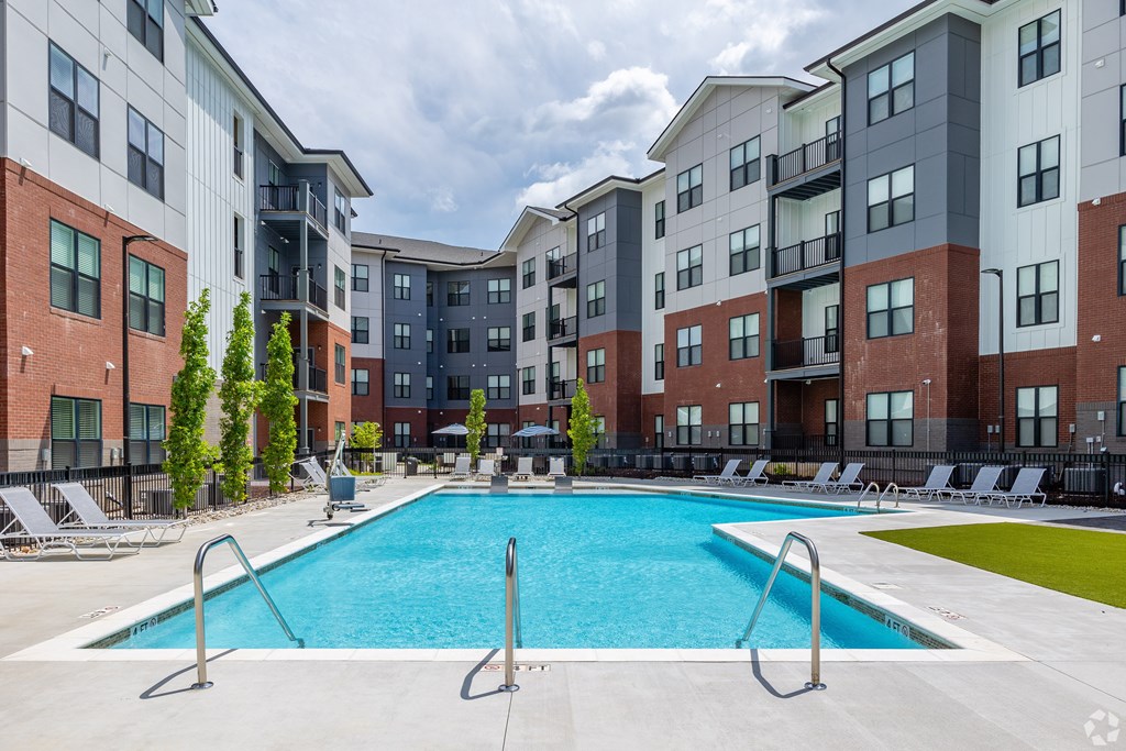 A swimming pool in front of apartment buildings.
