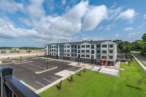 A large building with a parking lot in front of it.