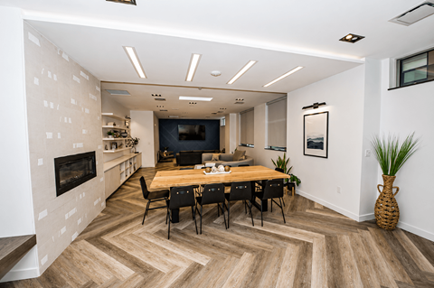 A modern dining room with a wooden table and chairs.
