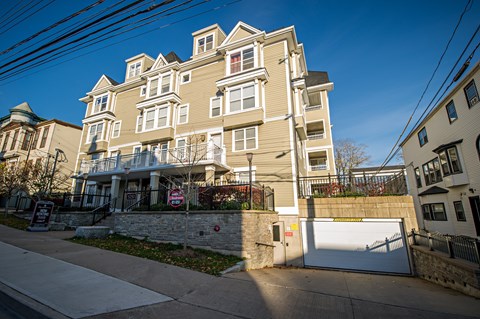 A large, multi-story building with a gated entrance and a "No Trespassing" sign in front.