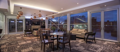 A modern dining room with a large table and chairs.