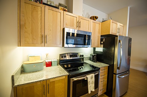 A kitchen with wooden cabinets and stainless steel appliances.