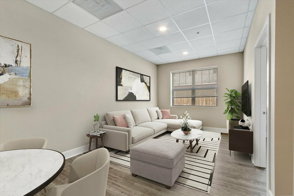 A living room with a couch, chairs, and a coffee table.